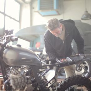 Man working on a motorcycle in a mechanic shop