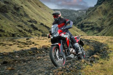 Rider on adventure motorcycle with chain drive
