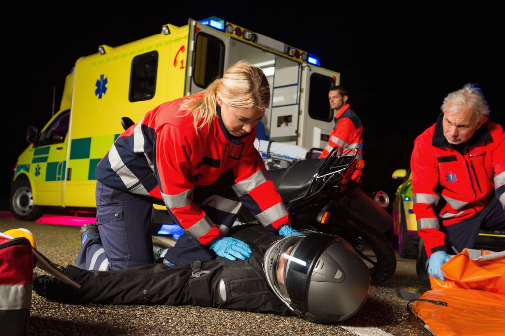 EMS helping a downed rider