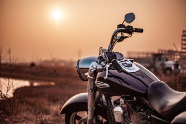 Black cruiser motorcycle outside near sunset
